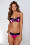 Woman wearing a pink and black lingerie set on a white background