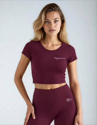 Model wearing burgundy t shirt and leggings